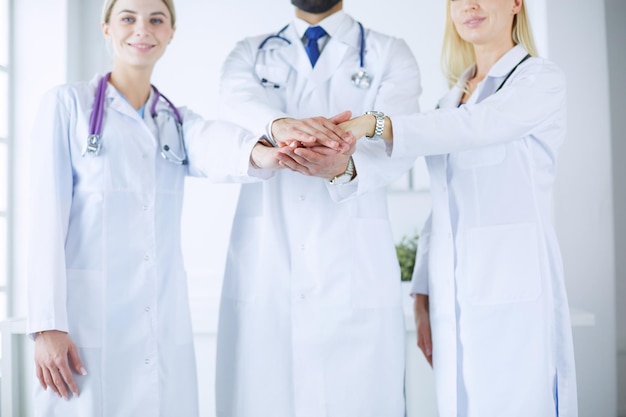 Doctors and nurses in a medical team stacking hands