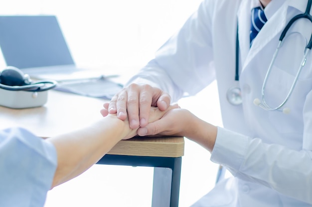 Doctors wear stethoscope hand to hand encouraging patients to be cured from illness