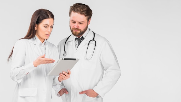 Doctors woman and man looking at tablet 