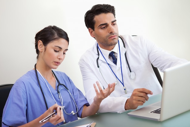 Doctors working with a laptop