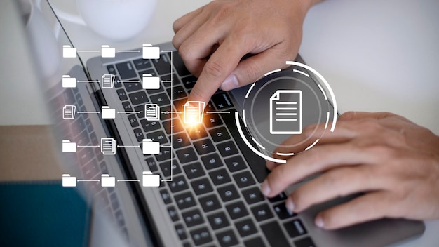 Document Management System DMS being setup by IT consultant working on laptop computer in office Software for archiving searching and managing corporate files and information