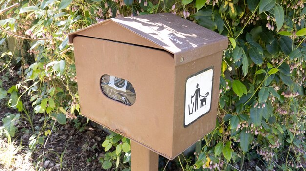 Dog poop Clean Up bag brown dispenser station in the park