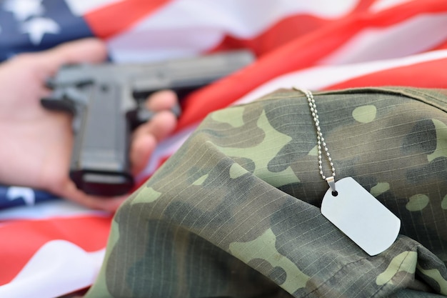 Dog tags lies with hand of depressive man who commit suicide with a gun