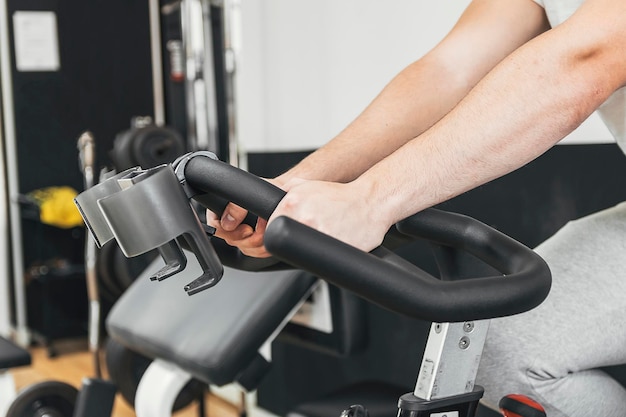 Doing cardio on the gym bike doing exercise