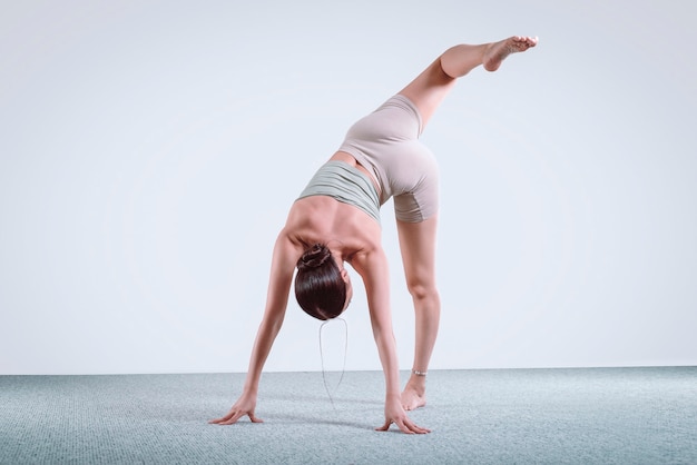 Doing fitness exercises, practicing yoga in class, young woman meditating at home. Training, fitness, mindfulness, workout, meditation, yoga, self-care, relaxation, pilates, healthy lifestyle concept