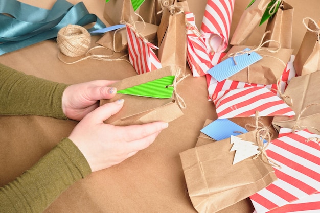 Doityourself advent calendar surprises for children from December to Christmas a woman wraps gifts