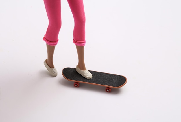 Doll legs ride on skateboard on white background Minimalism