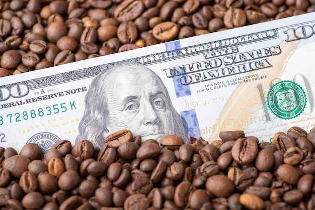 Dollar banknote in coffee grain Coffee business concept price on coffee beans