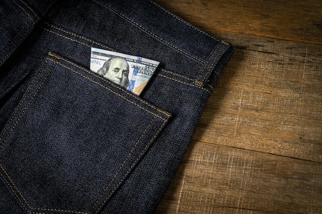 Dollar banknote in a jeans pocket.