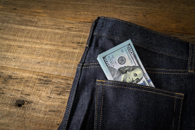 Dollar banknote in a jeans pocket.