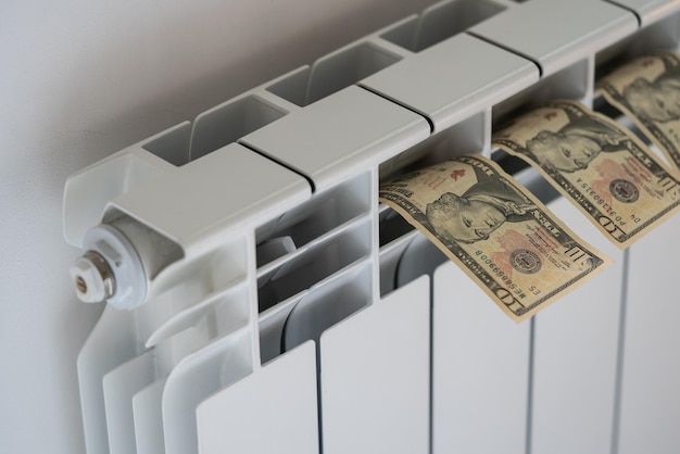 Dollar banknotes put on warm room heating battery to dry from accidentally soaking in water