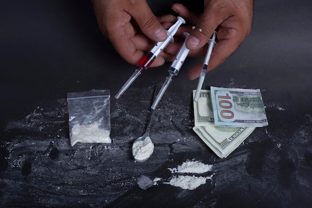 Dollar money cocaine and syringe