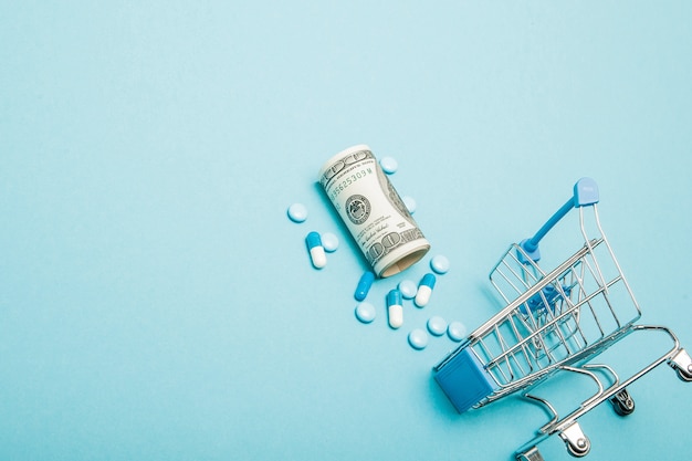 Dollars and shopping cart on a blue background