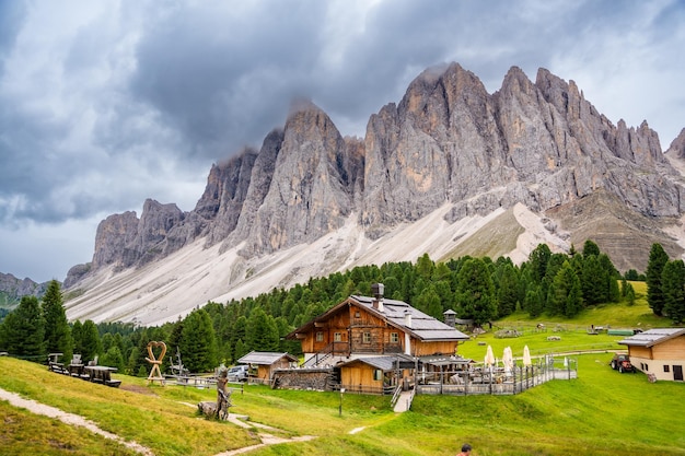 Dolomite landscape in puez odle nature park view from alpine plateau with wooden houses and green