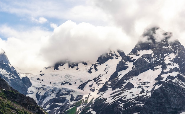 Dombay mountain range in the Caucasus in summer, snow-capped peaks and green mountain slopes