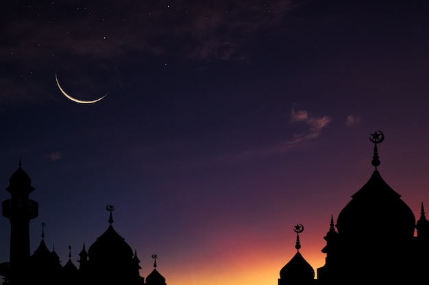 Dome mosque silhouette and crescent moon sky on dark blue dusk