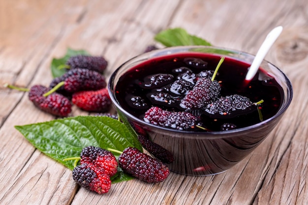 Domestic fresh mulberry jam on a rustic wooden board