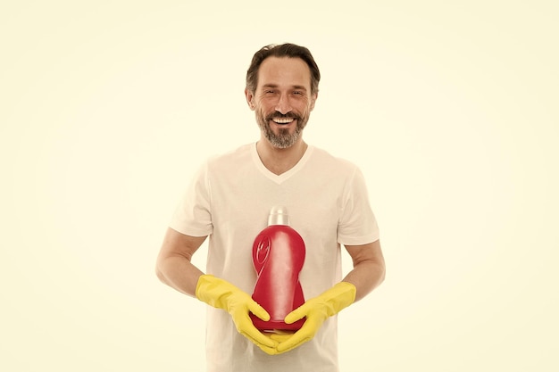 Domestic wash labor concept Bearded man with cleaning equipment mature man in yellow gloves Cleaner hold cleaning product soap for cleaning home man in rubber gloves with detergent bottle