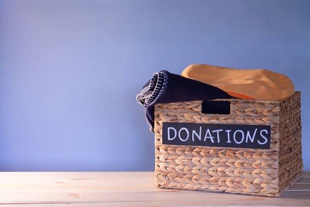 Photo donation box for clothing donations on a blue background. charity and donation concept. copy space.