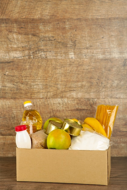 Donation box with food on the broun background