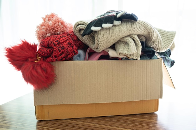 Donation box with used clothes at home to support help for poor people in the world