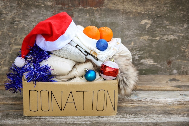 Donation box with winter clothes and with christmas decorations Gift