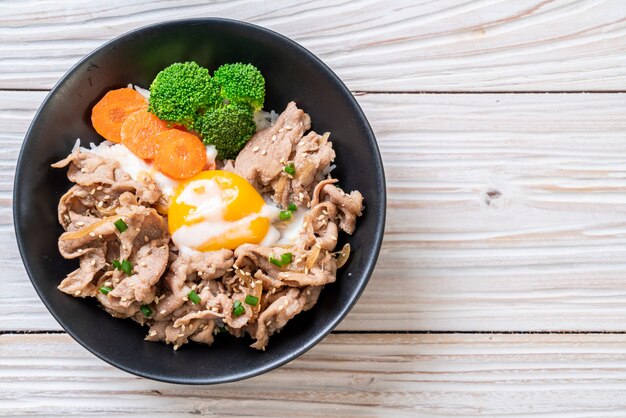 donburi, pork rice bowl with onsen egg and vegetable