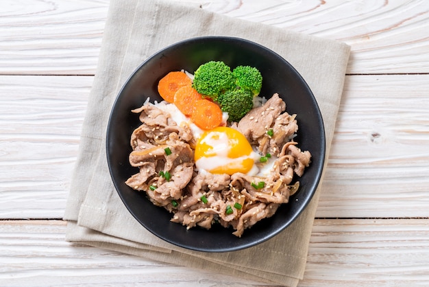 donburi, pork rice bowl with onsen egg and vegetable