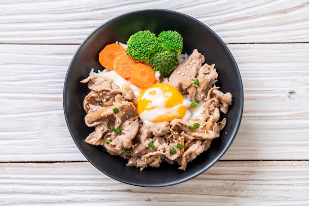 donburi, pork rice bowl with onsen egg and vegetable