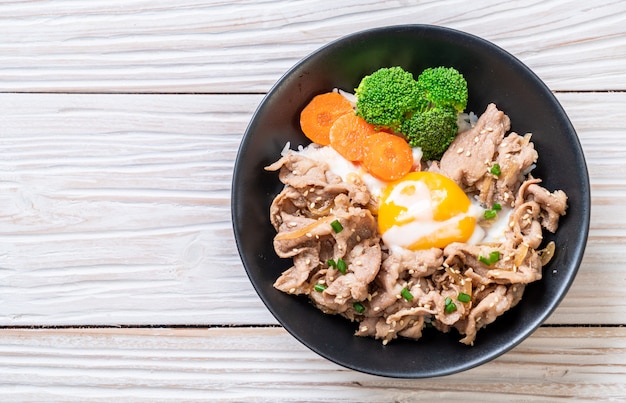 donburi, pork rice bowl with onsen egg and vegetable