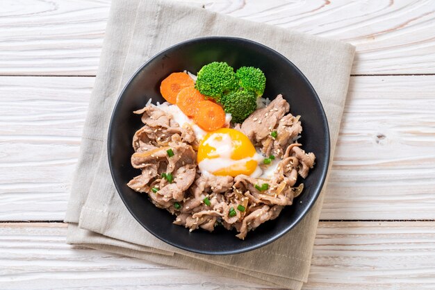 donburi, pork rice bowl with onsen egg and vegetable