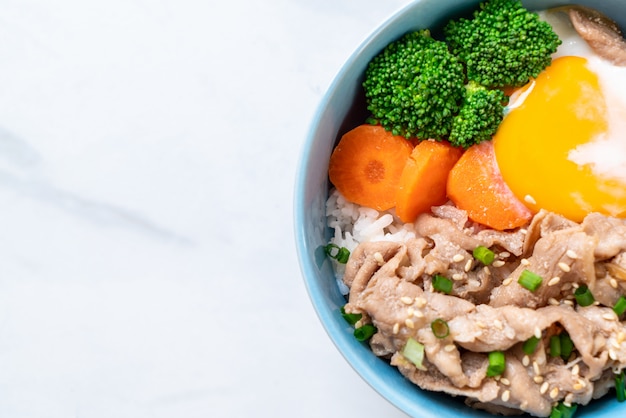 donburi, pork rice bowl with onsen egg and vegetable