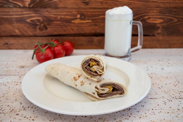 Doner kebab wrapped in lavash buttermilk tomato pepper