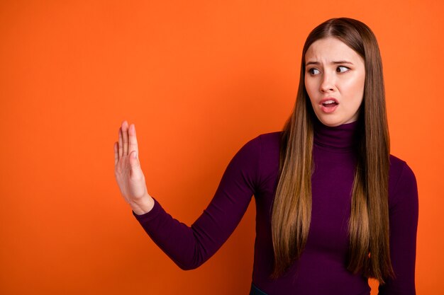 Dont do it. Frustrated girl hold hand look copyspace block refuse disgust grimacing wear jumper isolated over vivid color background