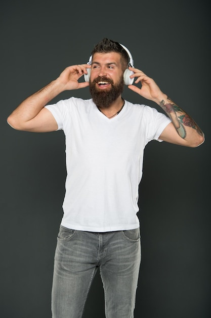 Dont stop music. Bearded man listen to music grey background. Hipster wear headphones playing music. Music is fun. Fun and entertainment.