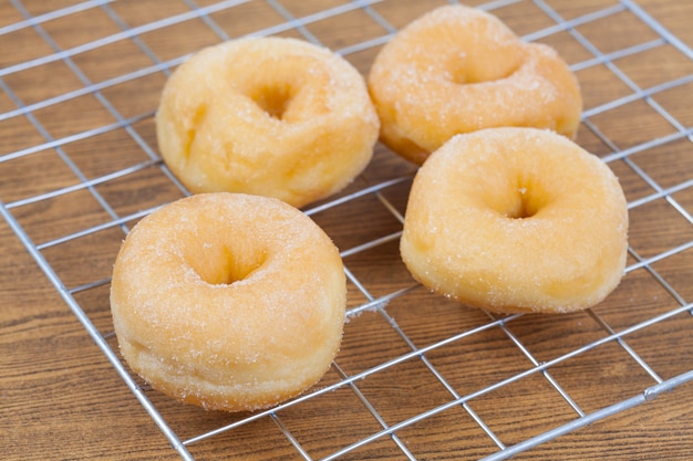 Donut on grille isolated on wood table.