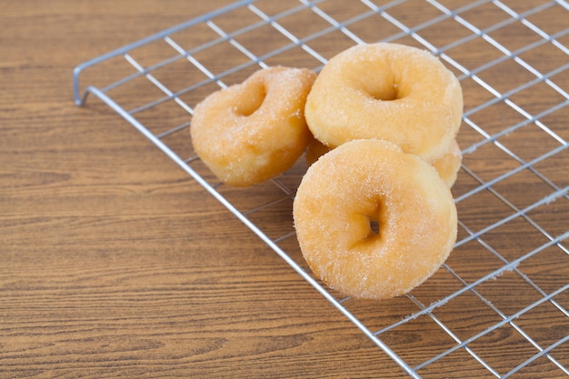 Donut on grille isolated on wood table.