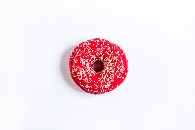 Donut red round with a powder in the center of a white background top view