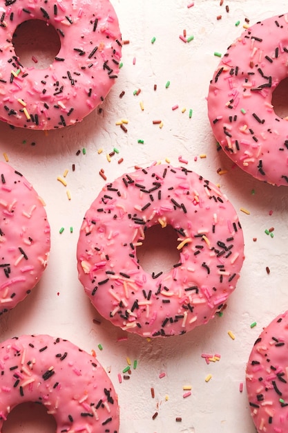 Donut with strawberries in pink glaze confectionery decoration top view