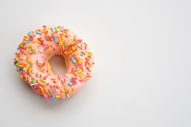 Donut with strawberry chocolate topping and colorful sugar breads 