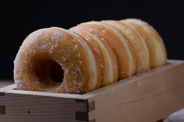 Donuts are arranging in the wooden box