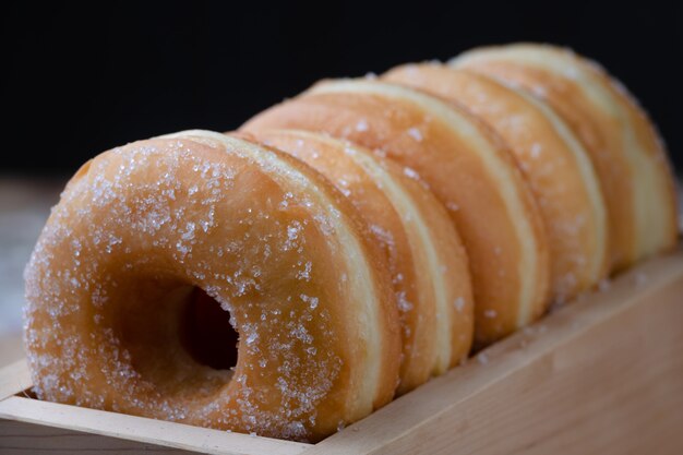 Donuts are arranging in the wooden box