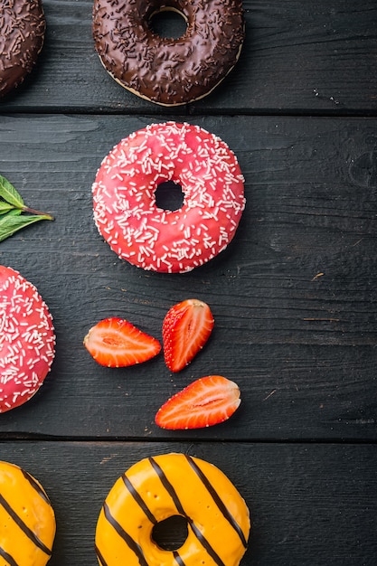 Donuts on black wooden table