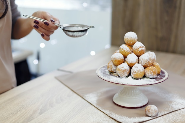 Donuts on a tray sprinkled with powdered sugar