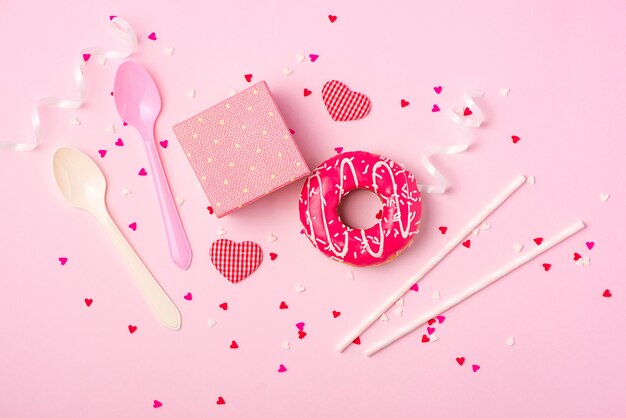 Donuts with icing on pastel pink background with copyspace. Sweet donuts.