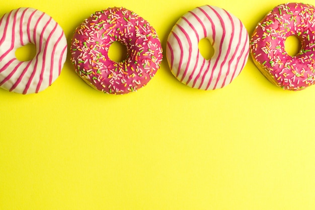 Donuts on yellow background. Sugar dessert