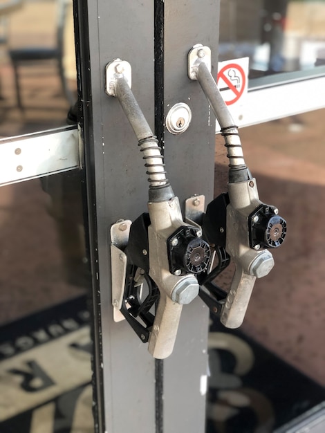 Door handle on gas station made of gasoline pistol pump fuel nozzle