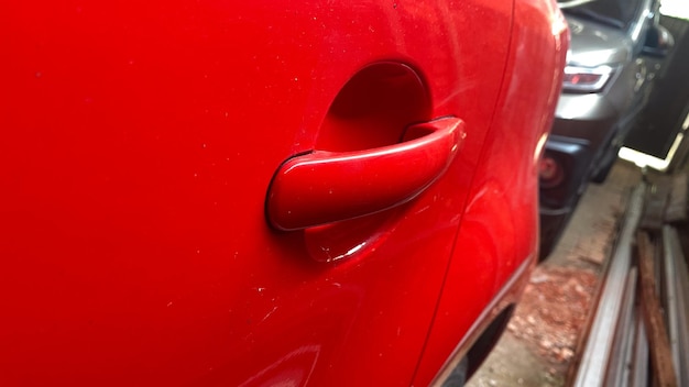 door handle on red car