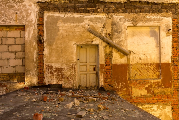 Door in a ruined house inside view  Total abandoned