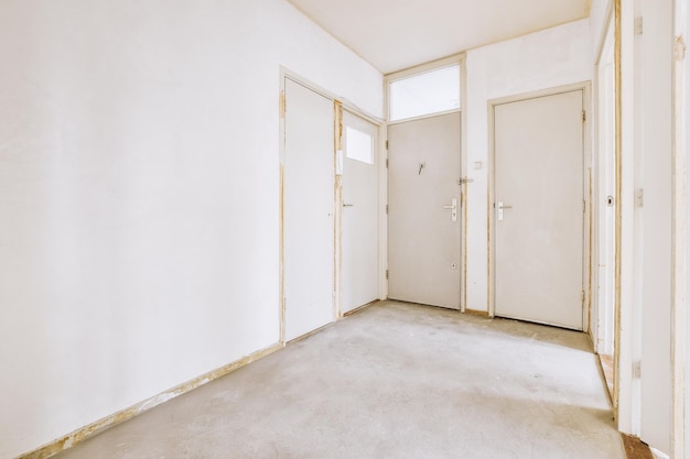 Doorway of modern apartment with white walls and parquet floor